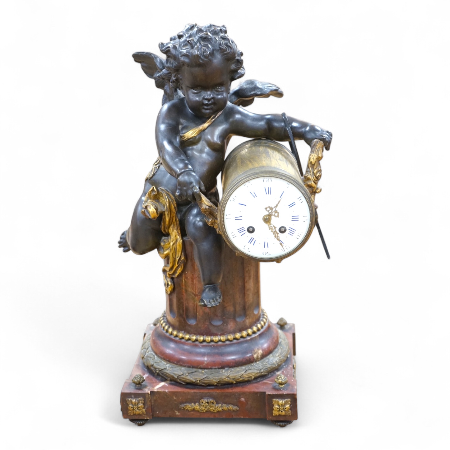 A large Louis XVI style bronze and rouge marble cherub clock, late 19th century, 56cm high